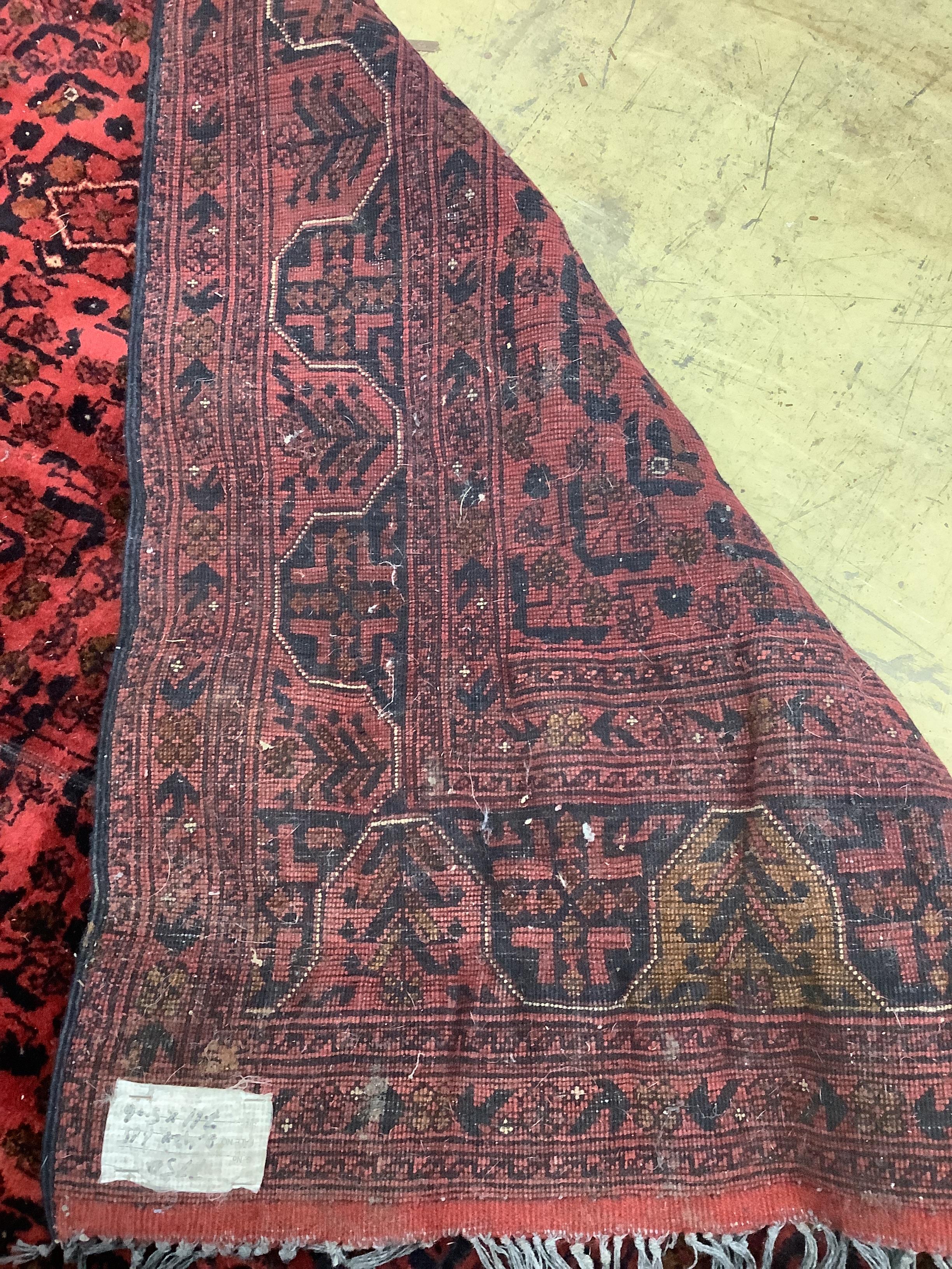 An Afghan red ground carpet, 246 x 164cm